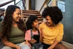 Image is of two women and a child