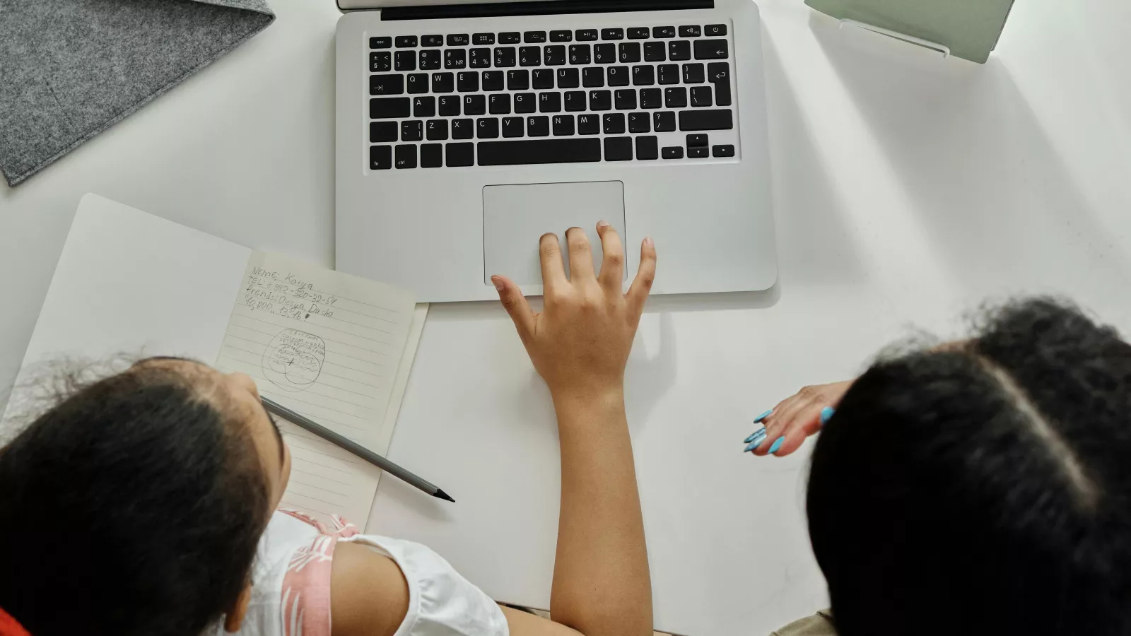 Image is of child and parent using a computer