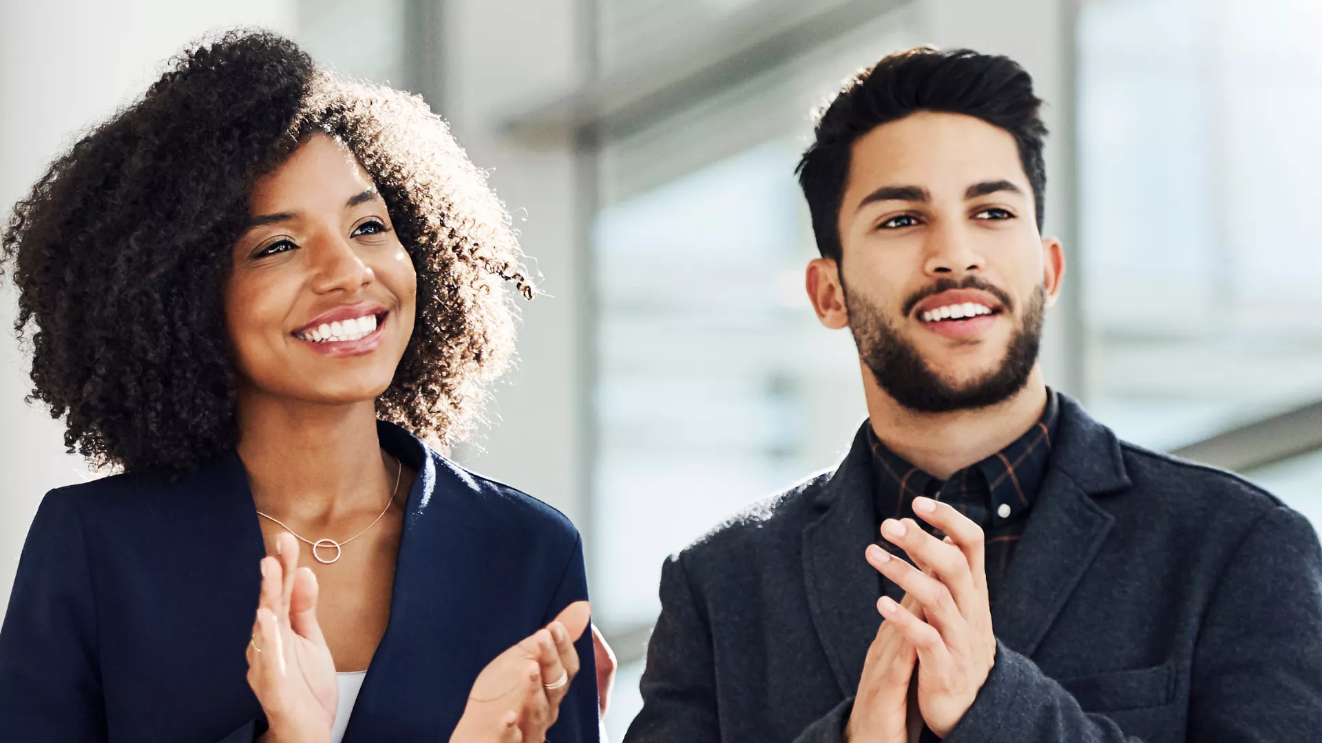 Image is of woman and man clapping