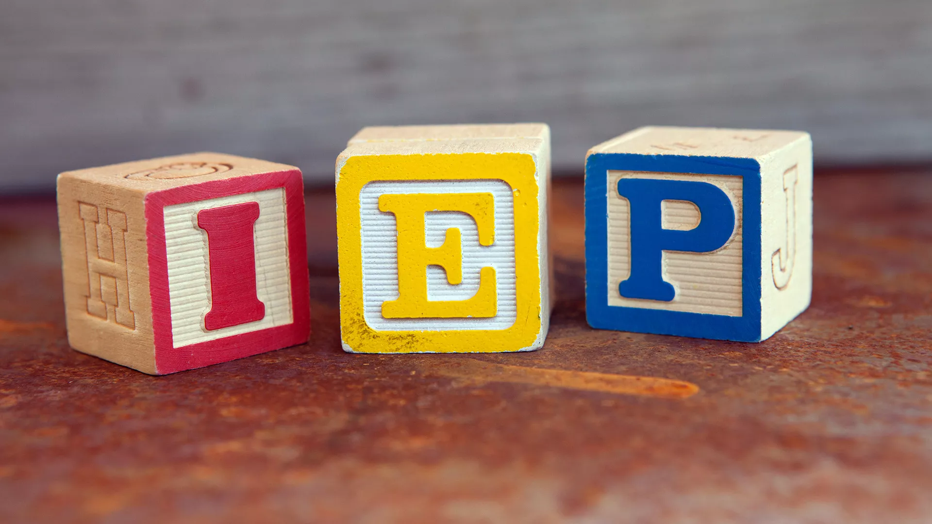 three wooden blocks with the letters I, E, P on them