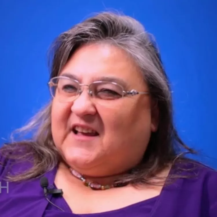 Suzanne Smith smiles into the camera